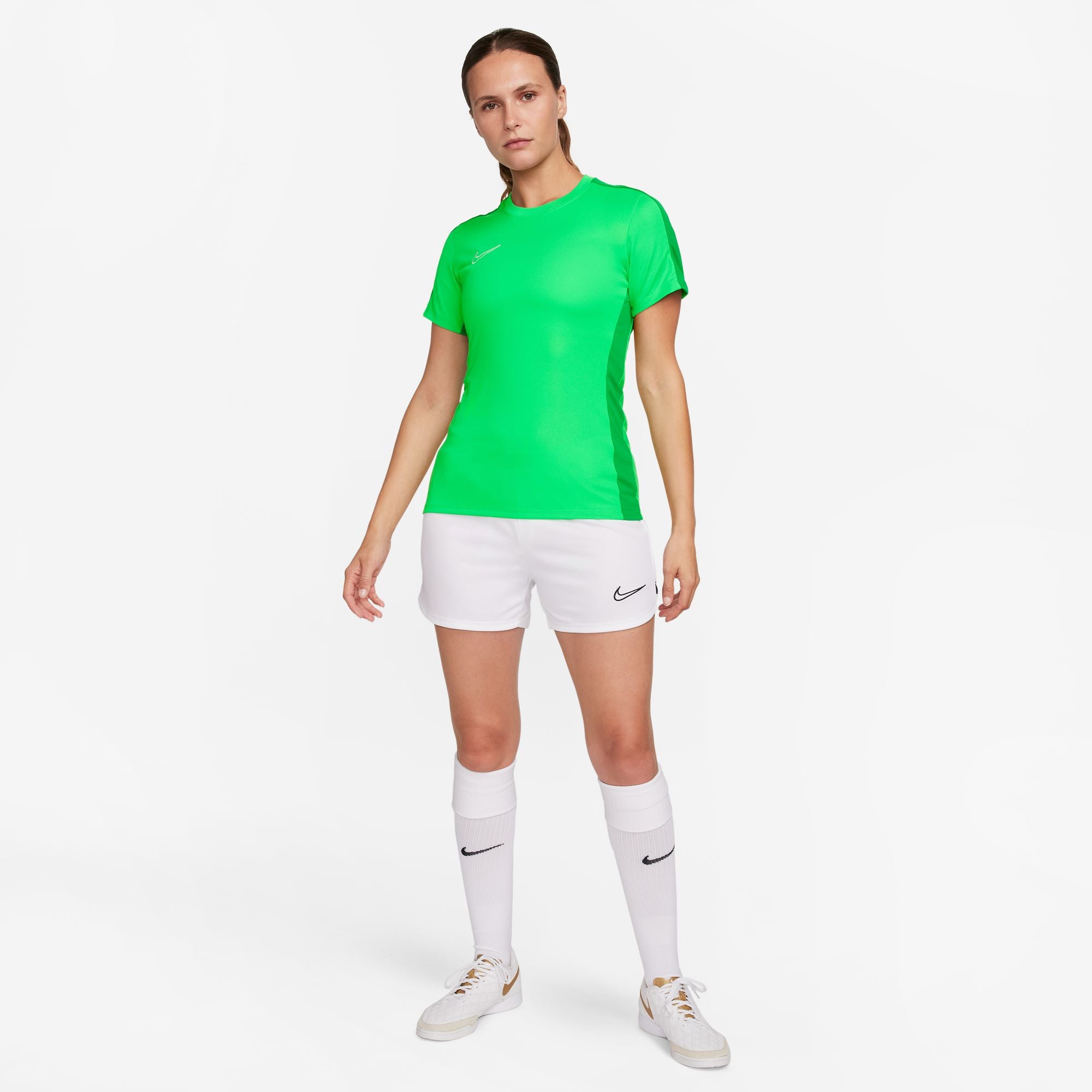 Nike Dri FIT Academy 23 Womens Short Sleeve Shirt in Green Spark/Lucky Green with white nike shorts and white nike socks and white and gold nike trainers