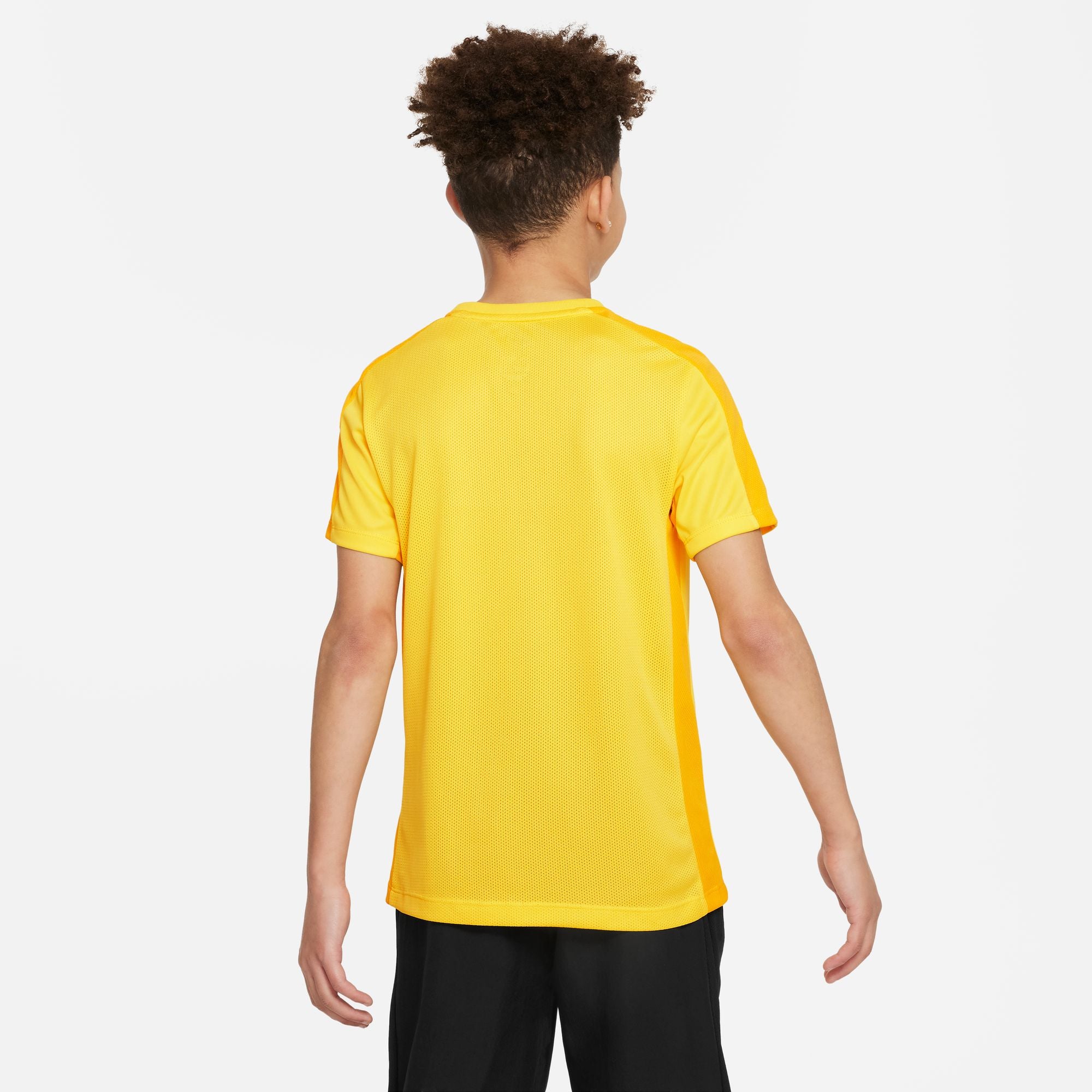 Back of Nike Dri FIT Academy 23 Short Sleeve Tour Yellow Shirt with nike university gold with black nike tracksuit bottoms