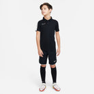 Nike Dri FIT Academy 23 Short Sleeve Polo in black with black nike shorts and black nike socks and white nike football boots