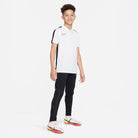 Nike Dri FIT Academy 23 Short Sleeve Polo in White/Black with black nike tracksuit bottoms and white nike football boots