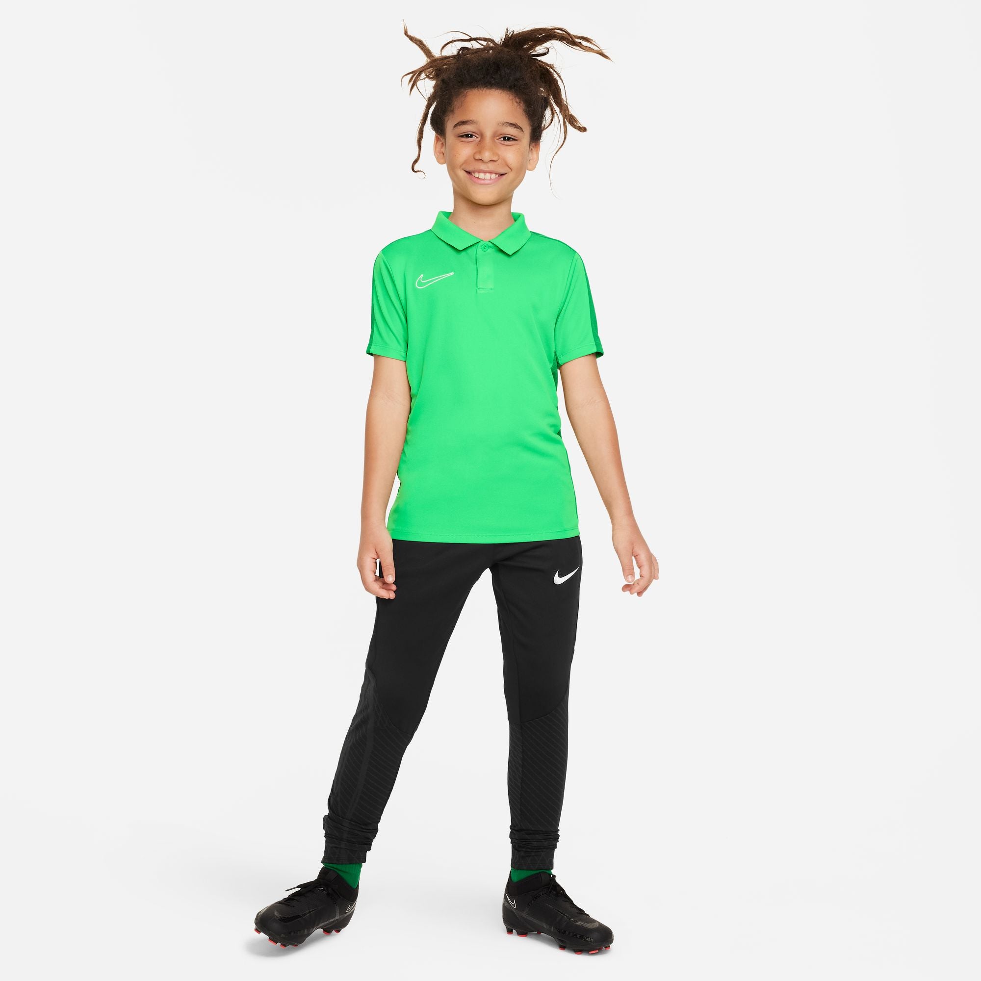 Nike Dri FIT Academy 23 Short Sleeve Polo in Green Spark/Lucky Green with black nike tracksuit bottoms and black trainers