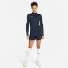 Nike Dri FIT Academy 23 1/4 Zip Women's Drill Top in dark blue obsidian and volt with navy nike shorts and white nike trainers and white nike socks