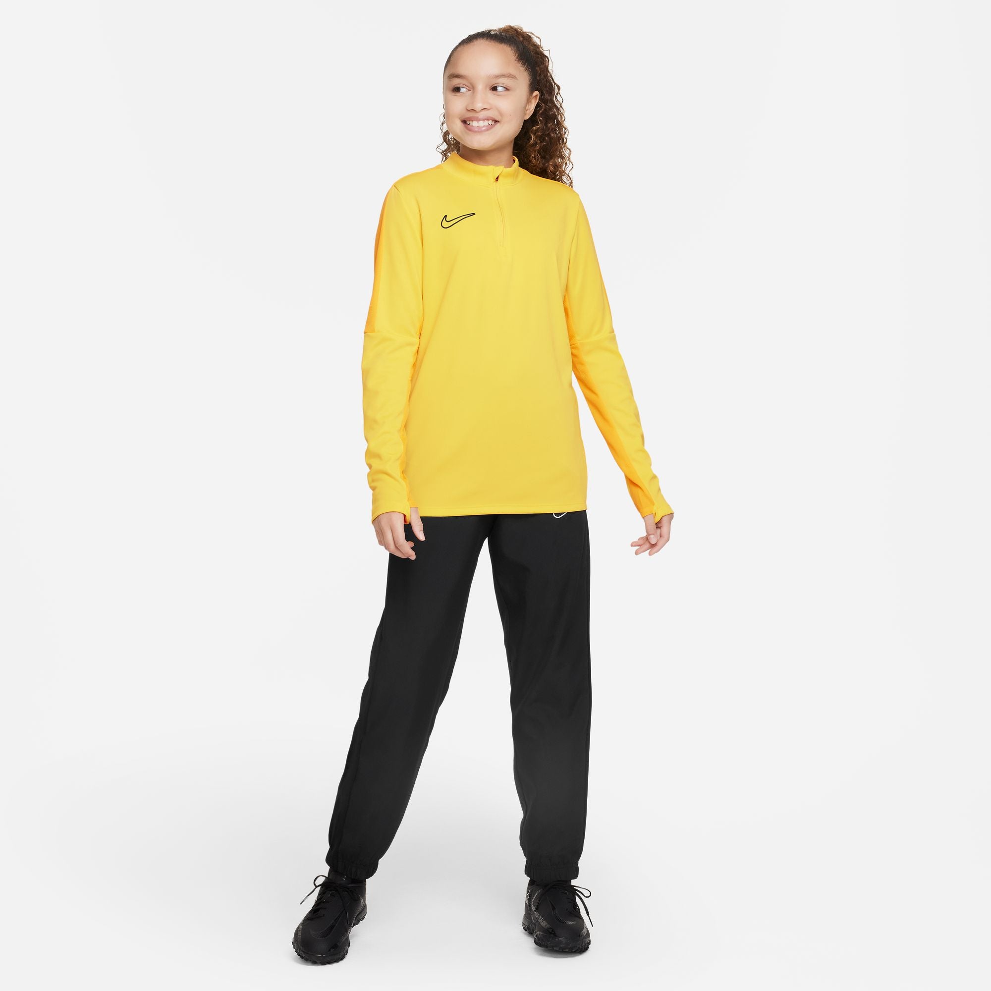 Nike Dri FIT Academy 23 1/4 Zip Tour Yellow/University Gold Drill Top with black nike tracksuit bottoms and black nike trainers