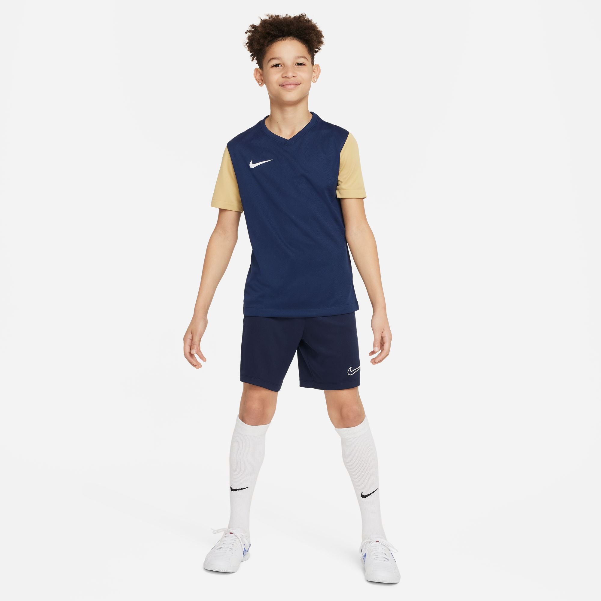 Nike Dri FIT Academy 23 Knit Shorts in dark blue nike obsidian with nike white socks and nike white trainers and blue v neck tee with gold sleeves