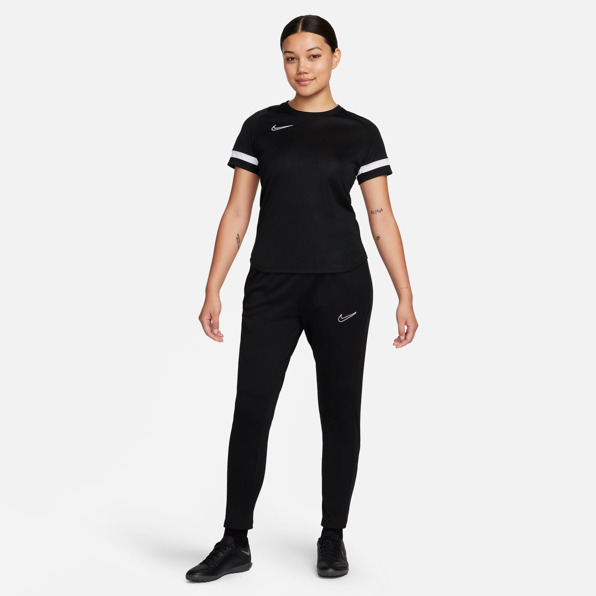 Nike Dri FIT Academy 23 Women's Knit Pants in black with black nike tracksuit bottoms and black nike trainers and black nike tee